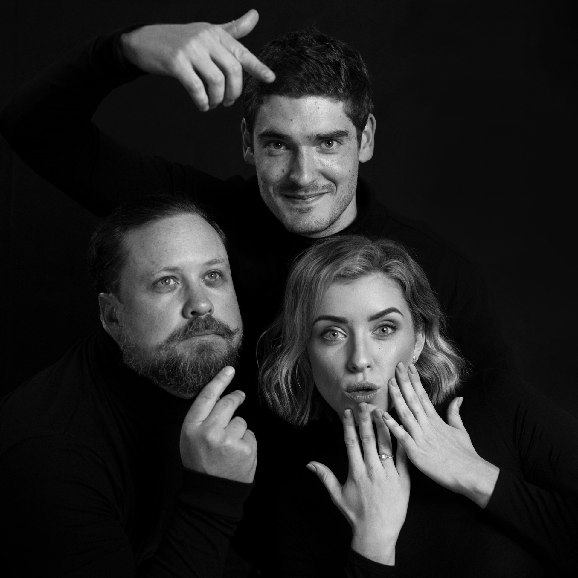Three people posing playfully